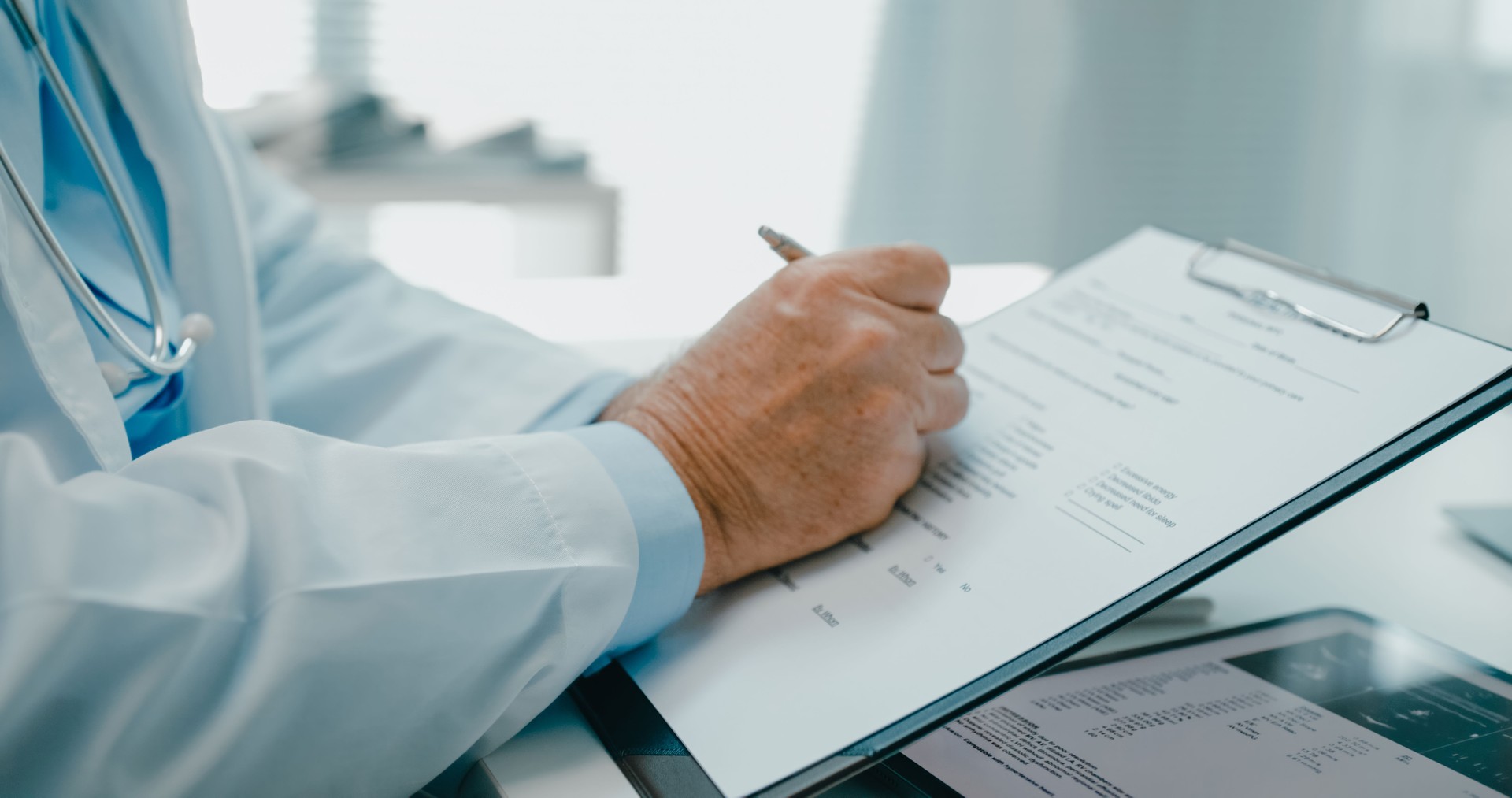 Close-up of senior doctor in lab coat reviewing a medical report on clipboard, focusing on patient records in clinical office. Medical health care.