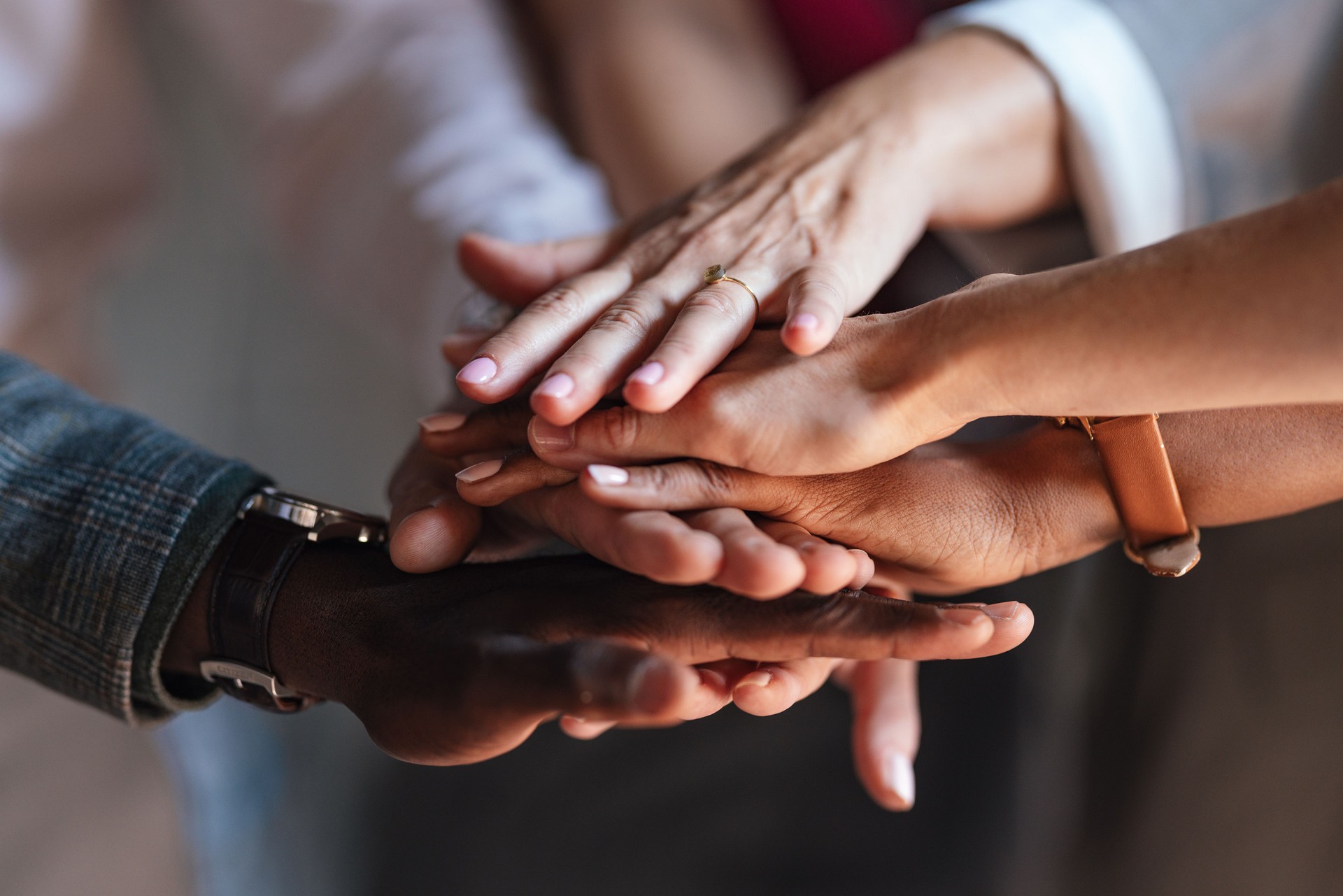 Diverse Group of People Joining Hands in Unity