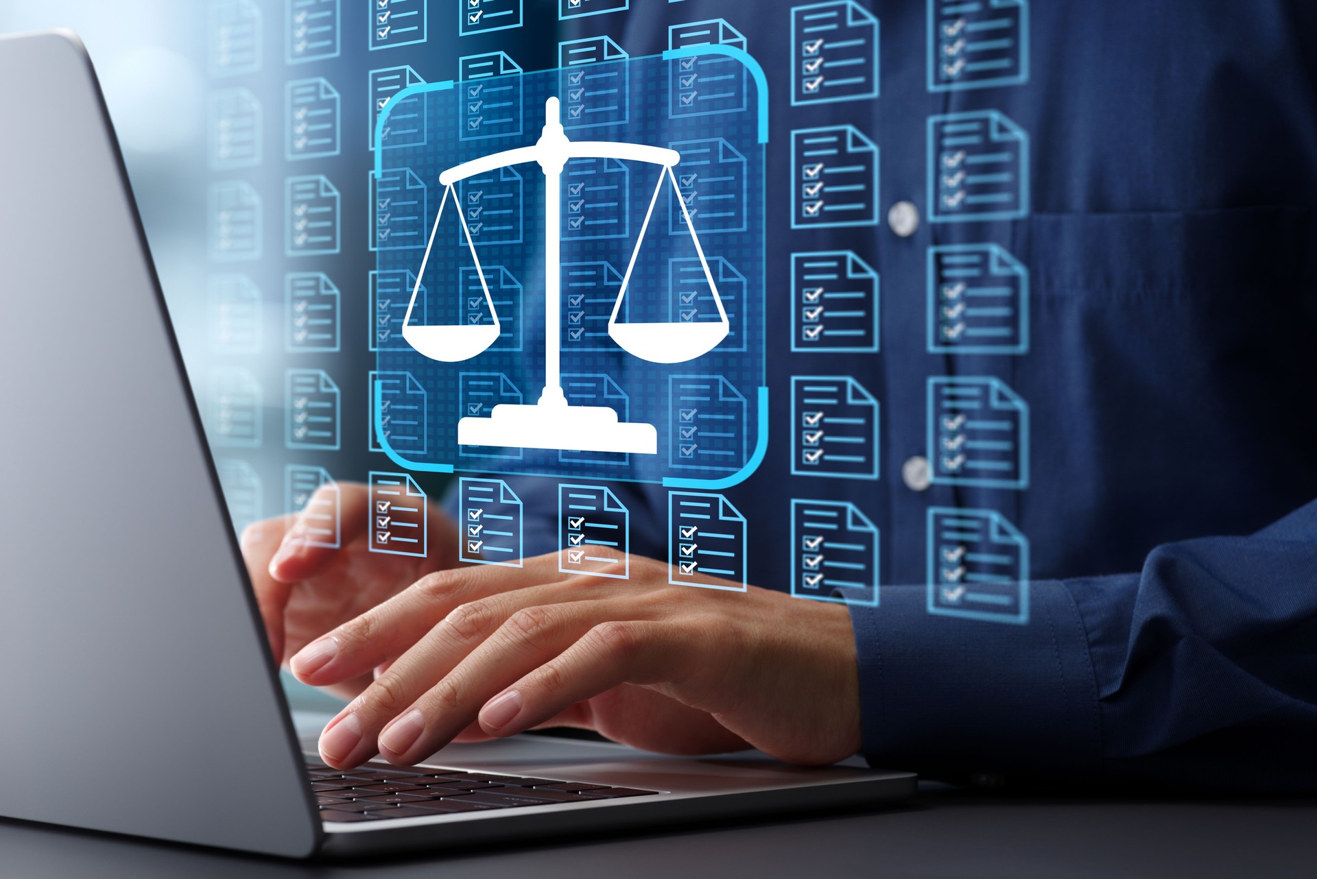 Compliance system management of legal document. Business and DMS technology. Balance scale icon and hands typing on laptop computer keyboard at desk in office.